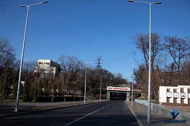Опоры уличного освещения рядом с железнодорожным мостом