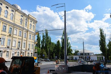 Опоры контактной сети на тротуаре вдоль проезжей части